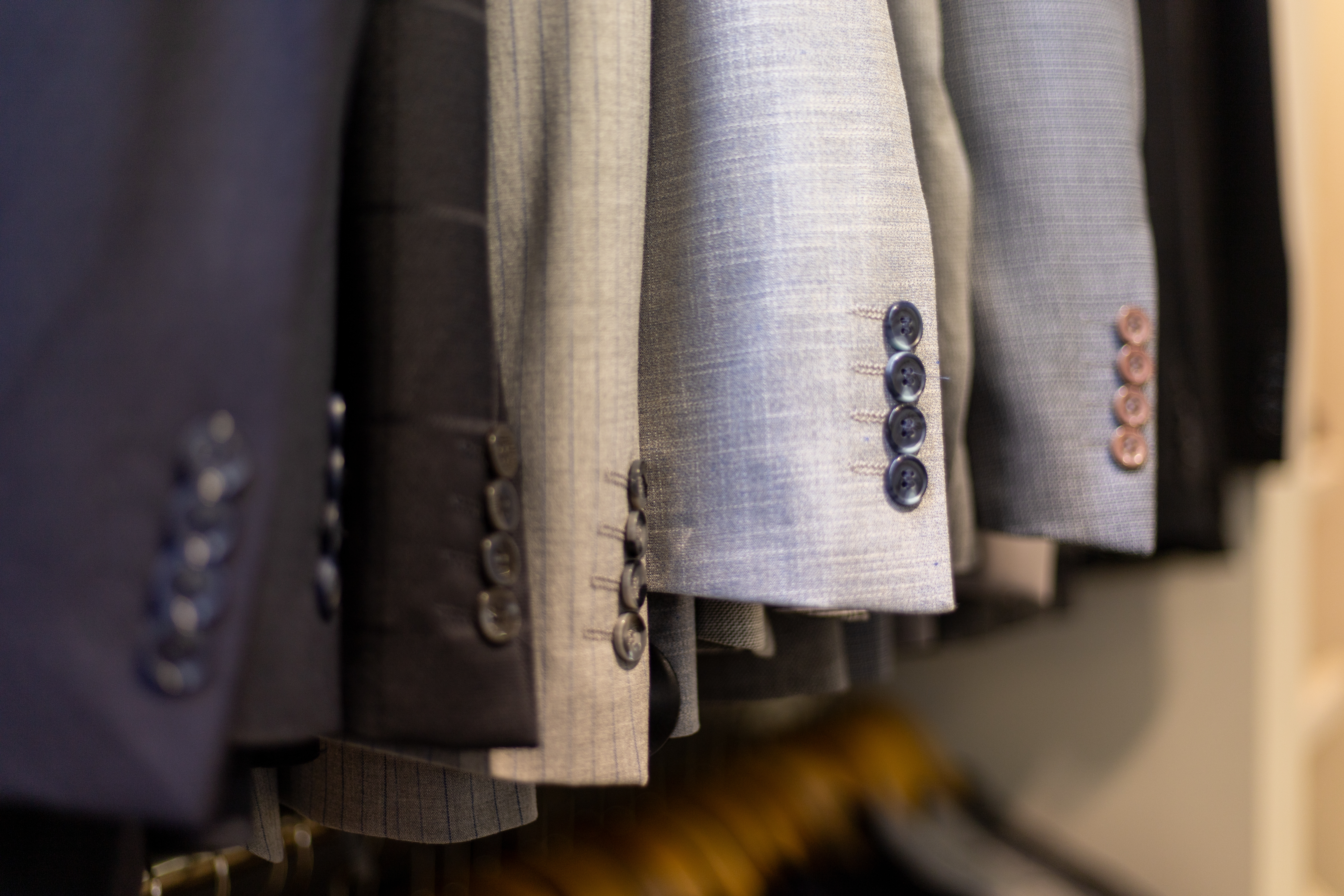 Finished bespoke jackets on wooden atelier hangers